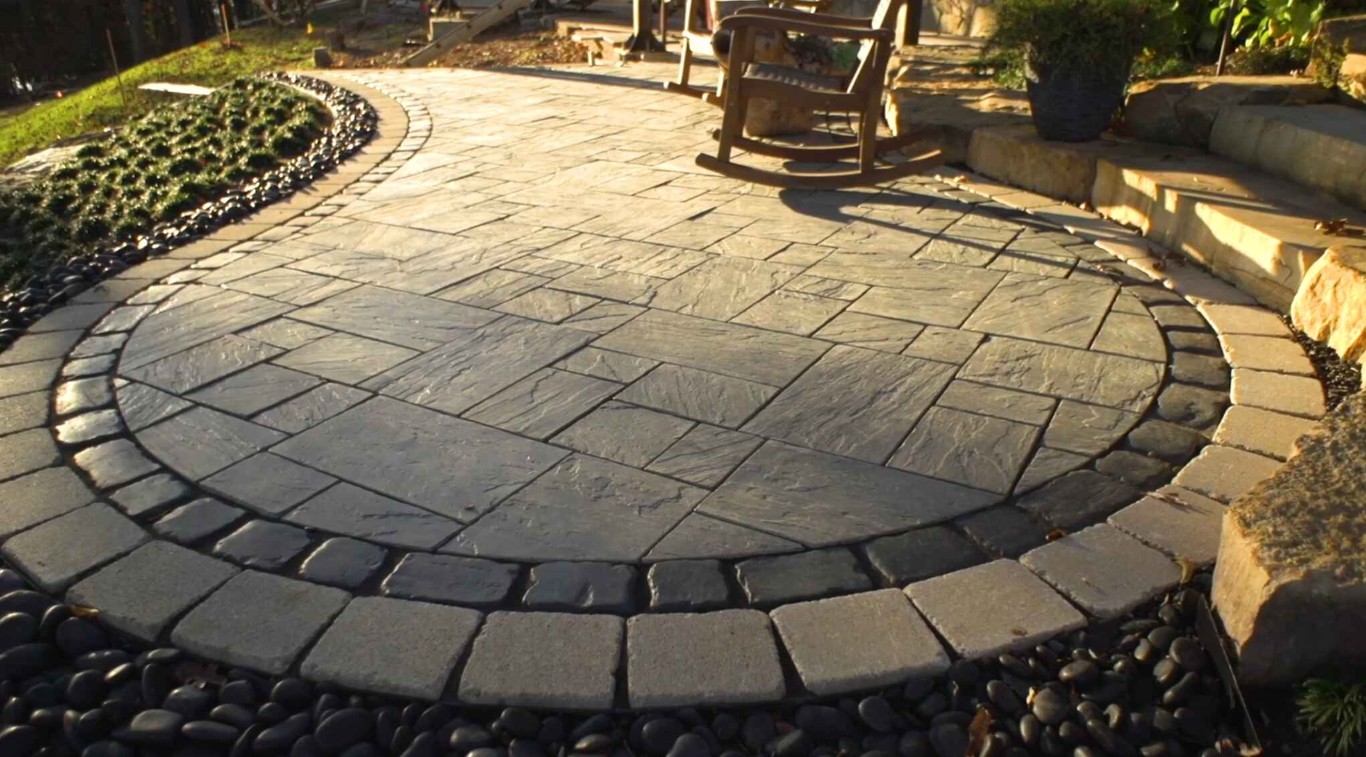 Circular paver patio with professional landscape lighting